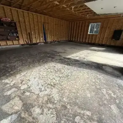 Concrete garage floor before coating — bare and stained